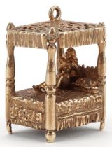 Large 9ct gold charm in the form of a nude female on a four poster bed, 2.4cm high, 12.2g
