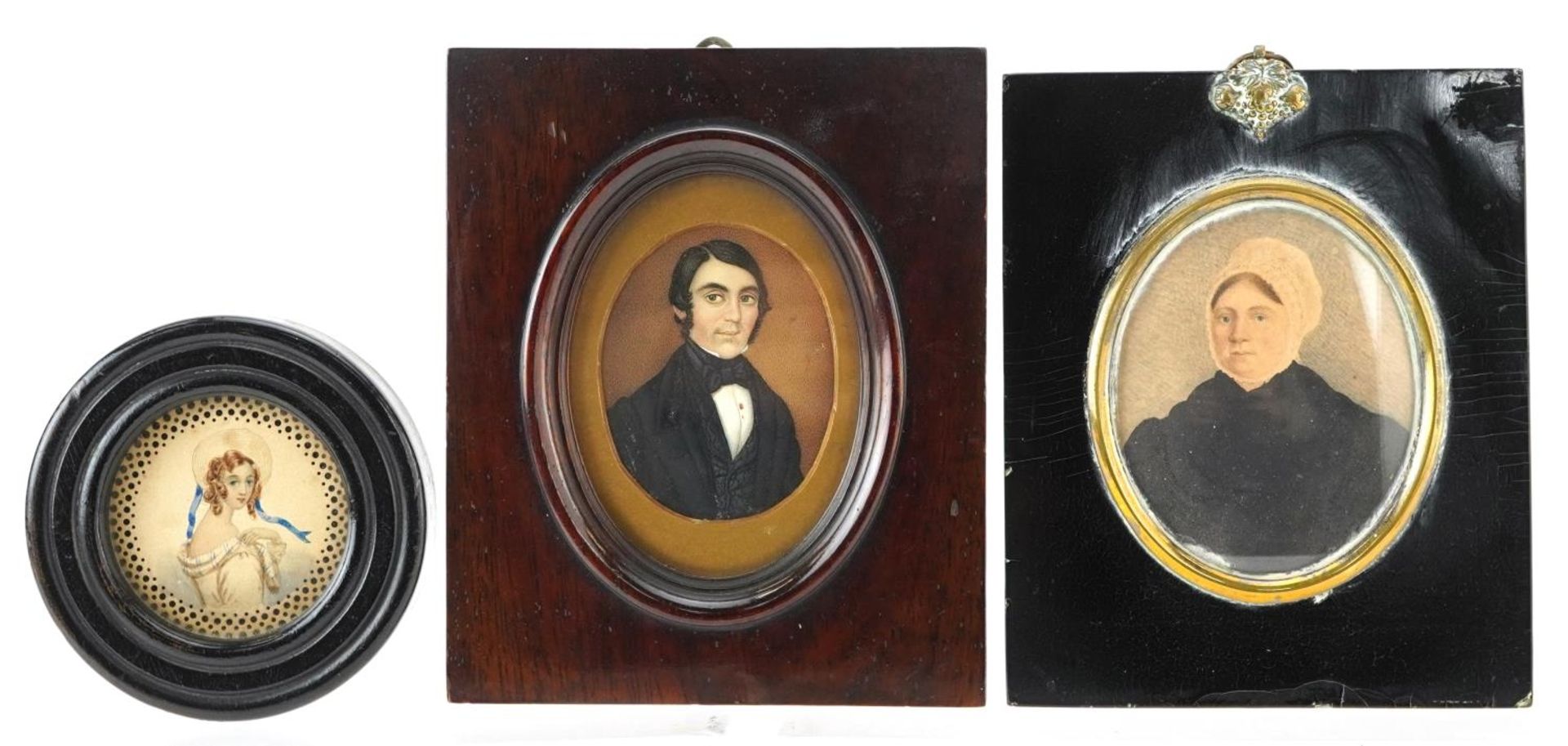 Three Georgian and later hand painted portrait miniatures including one of a gentleman wearing a