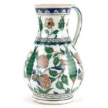 Turkish Ottoman Iznik water jug hand painted with stylised flowers and foliage, 24.5cm high
