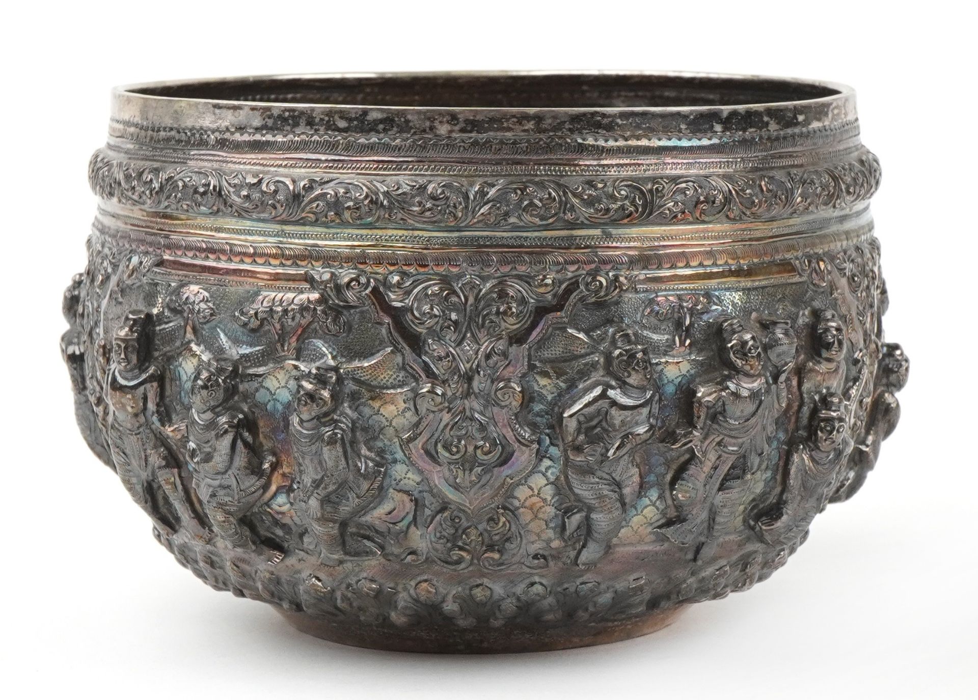 Burmese unmarked silver bowl profusely embossed with deities and animals within landscapes, 12cm