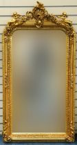 Large ornate gilt framed mirror having bevelled glass mounted with Putti and swags, 62cm x 84cm