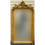Large ornate gilt framed mirror having bevelled glass mounted with Putti and swags, 62cm x 84cm