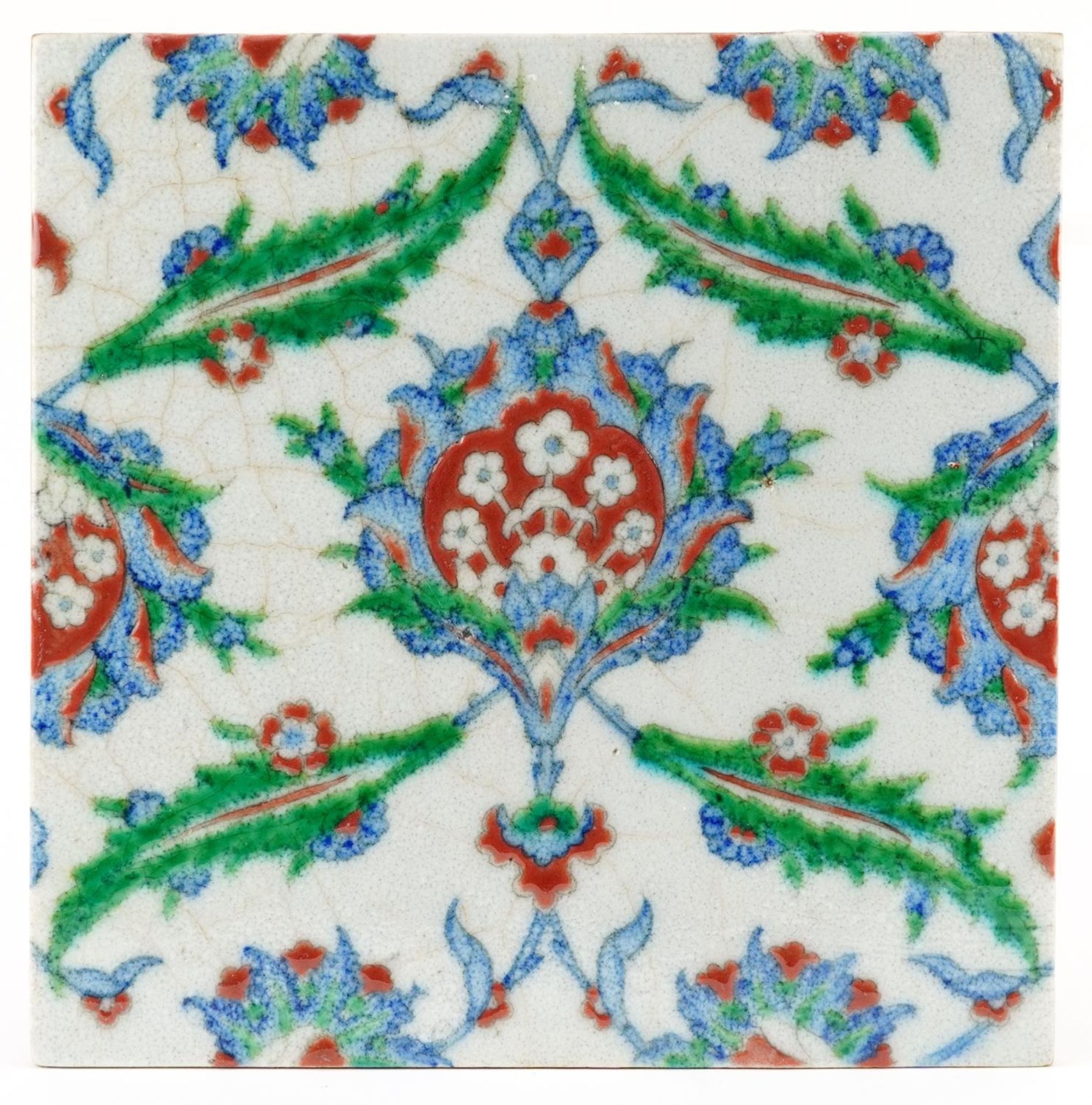 Turkish Ottoman Iznik tile hand painted with stylised flowers, 25cm x 24.5cm