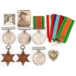 Six British military World War II medals, love heart sweetheart pendant and two photographs