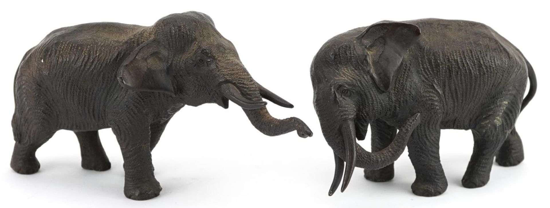 Two Japanese patinated bronze elephants, Meiji period, each with character marks to the feet, the