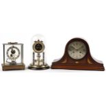 Three clocks comprising a Napoleon hat shaped inlaid mahogany mantle, Kundo electronic and German