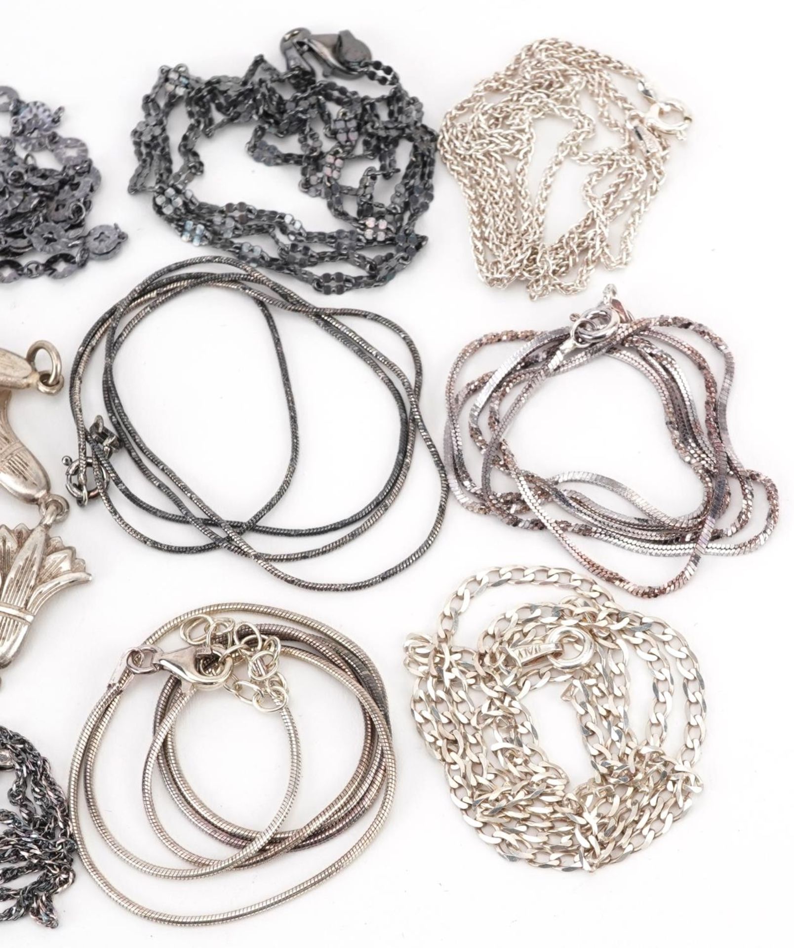 Silver jewellery comprising eleven necklaces and two floral bracelets, 55.0g - Image 3 of 3