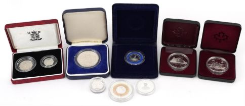 Nine silver proof coins, some with cases, including 1990 silver proof five pence two coins set,