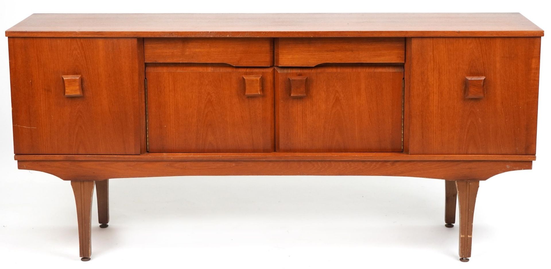 Mid century teak sideboard fitted with an arrangement of two drawers and four cupboard doors, 76cm H
