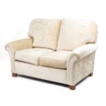Contemporary beige upholstered two seater settee, 100cm H x 145cm W x 100cm D