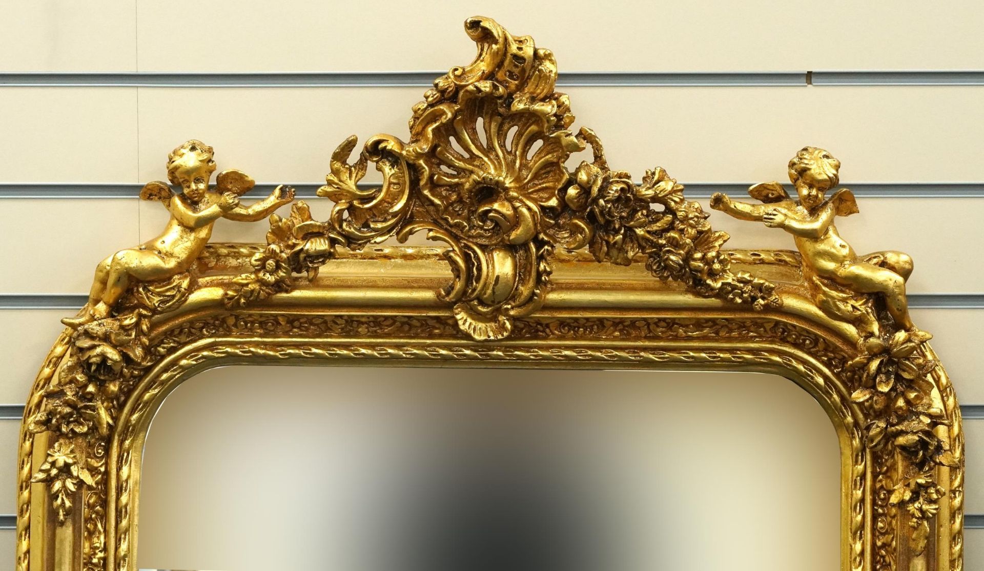 Large ornate gilt framed mirror having bevelled glass mounted with Putti and swags, 62cm x 84cm - Image 2 of 3