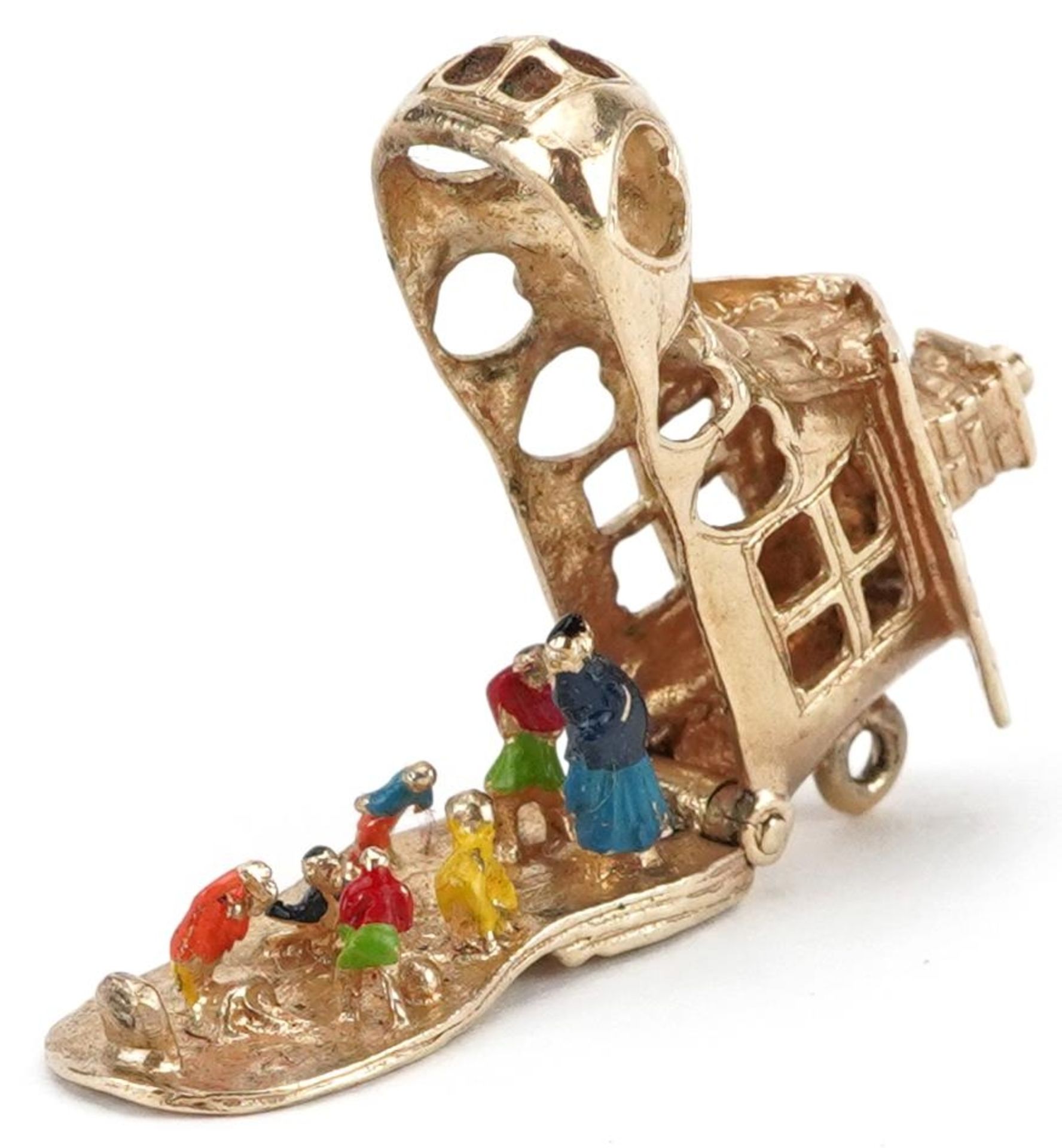 9ct gold and enamel opening charm in the form of The Old Woman Who Lived in a Shoe, 3.1cm in length,