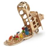 9ct gold and enamel opening charm in the form of The Old Woman Who Lived in a Shoe, 3.1cm in length,