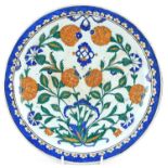 Turkish Ottoman Iznik footed plate hand painted with stylised flowers, 30cm in diameter