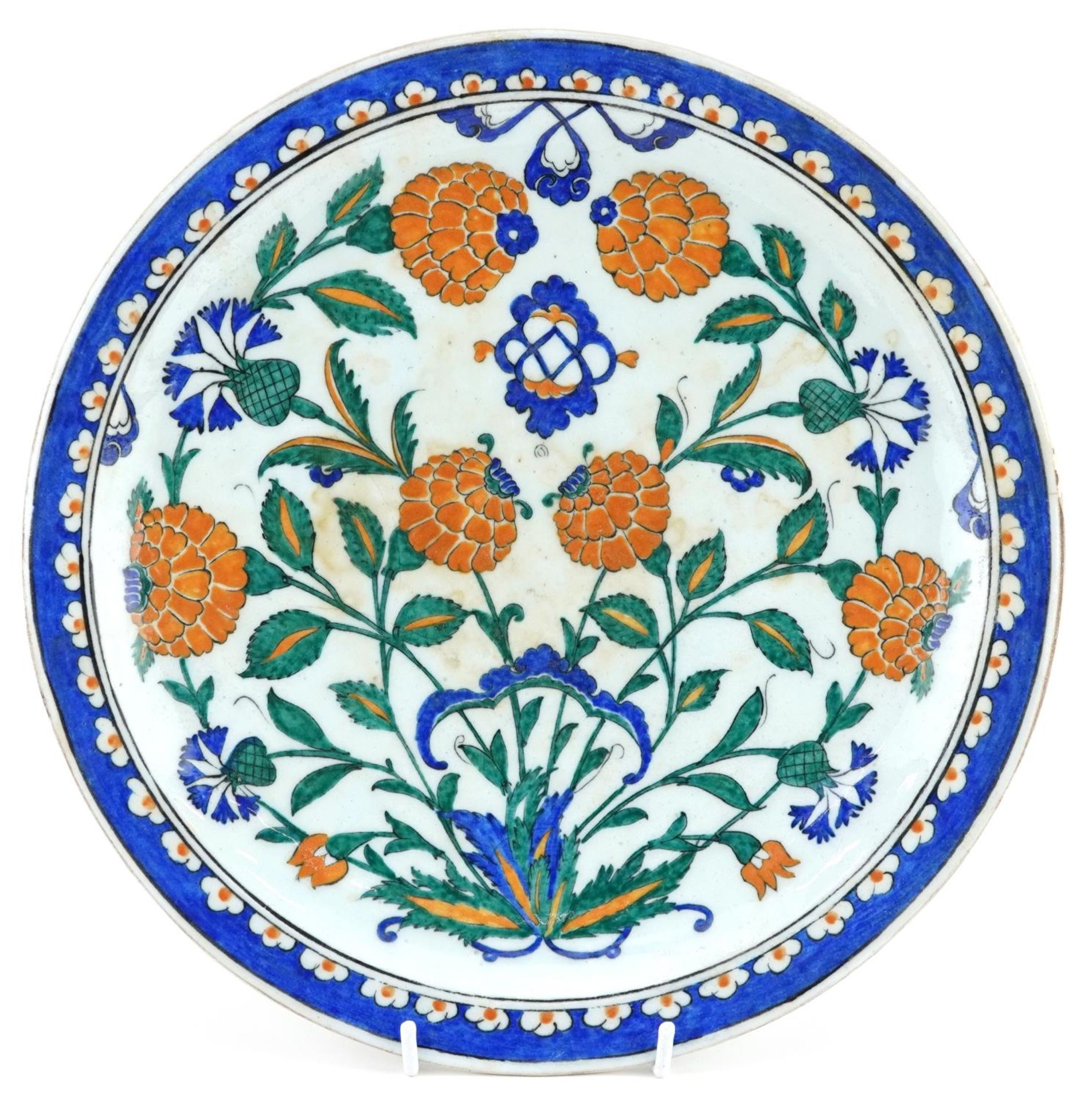 Turkish Ottoman Iznik footed plate hand painted with stylised flowers, 30cm in diameter