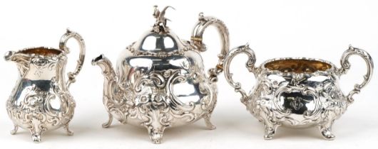 A B Savory & Sons, Victorian silver Rococo style three piece tea service profusely embossed with