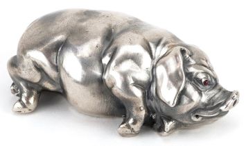 Silver recumbent pig with cabochon ruby eyes, impressed Russian marks to the base, 7cm in length,