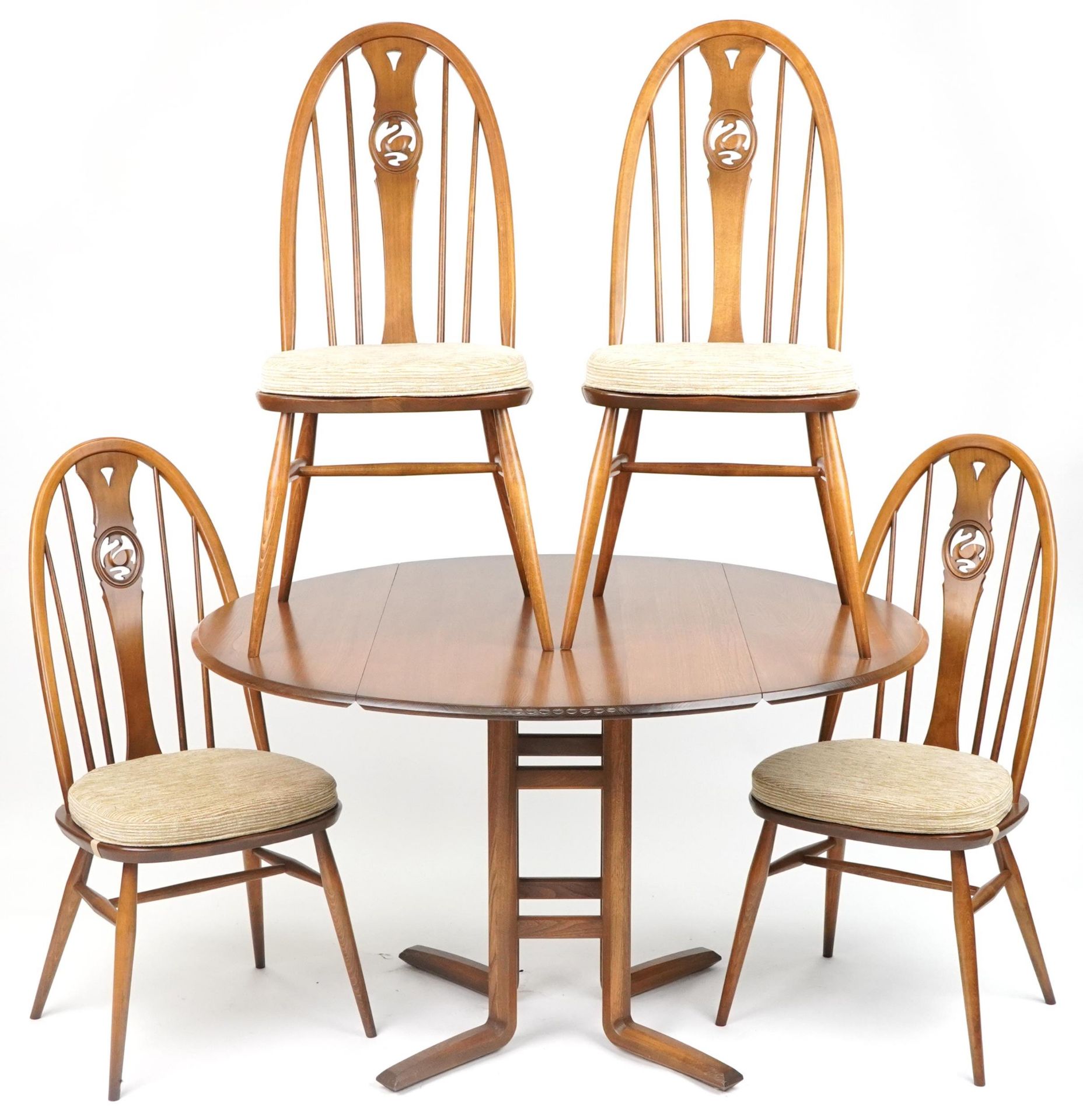 Ercol elm drop leaf dining table with four chairs carved with swans, the table 74cm H x 63cm W x