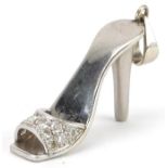 Unmarked white gold diamond charm in the form of a high heeled shoe, tests as 18ct gold, 3.5cm in