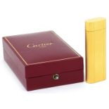 Cartier, gold plated French engine turned pocket lighter with box numbered D24339, 7cm high