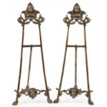 Pair of Rococo style brass easel stands, each 56cm high