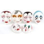 Five Taiwanese hand painted porcelain face masks, the largest 18cm high
