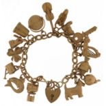 9ct gold charm bracelet with a collection of mostly 9ct gold charms including Good Luck spinner,