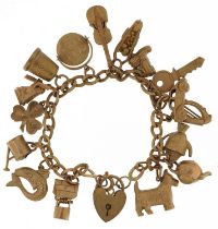 9ct gold charm bracelet with a collection of mostly 9ct gold charms including Good Luck spinner,