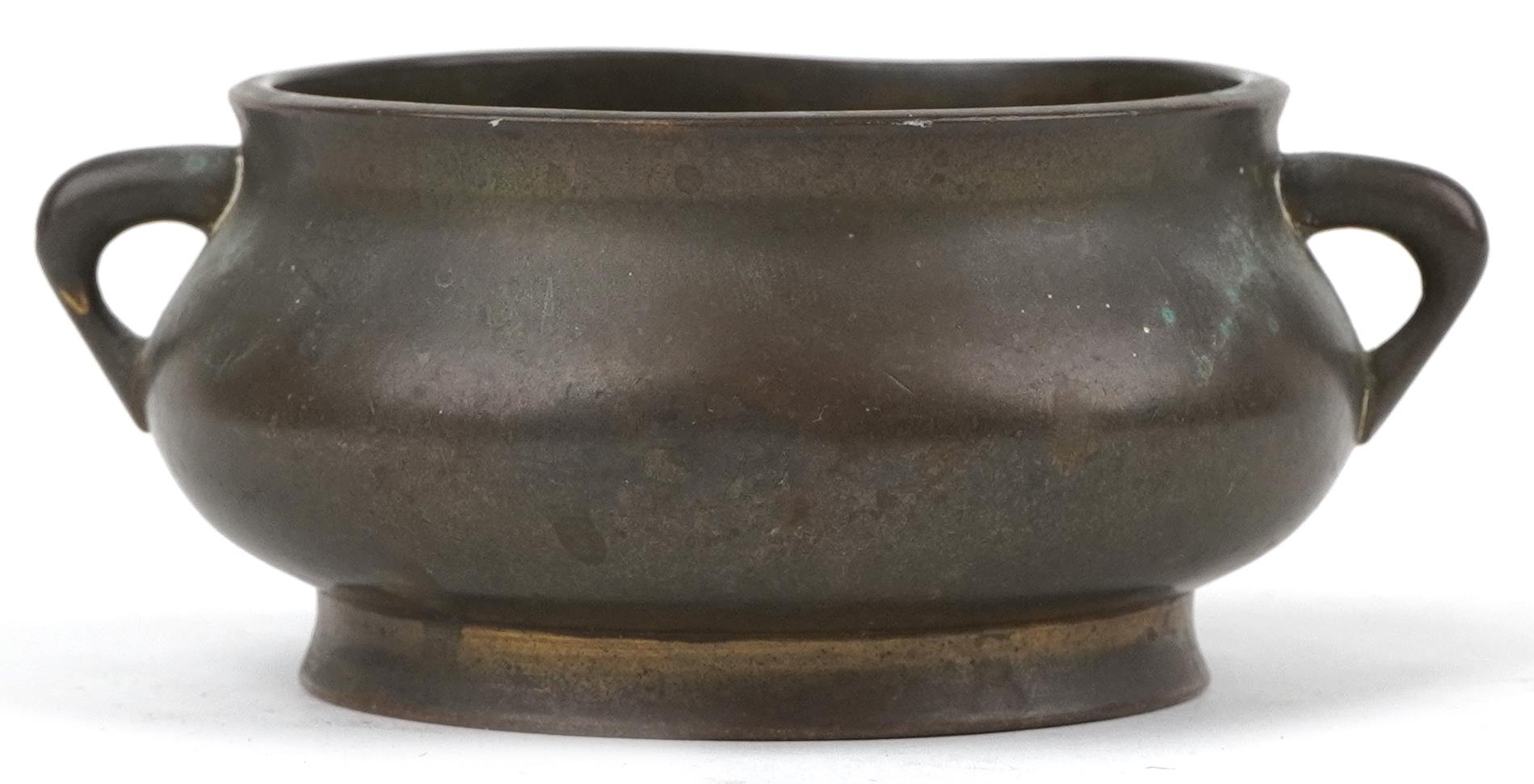 Chinese patinated bronze censer with twin handles, six figure character marks to the base, 12cm wide