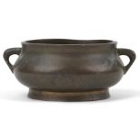 Chinese patinated bronze censer with twin handles, six figure character marks to the base, 12cm wide