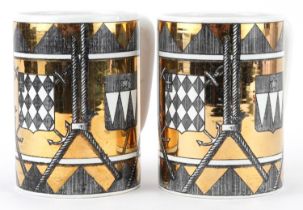 Piero Fornasetti, pair of vintage Italian gold lustre mugs decorated with shields, each 12.5cm high