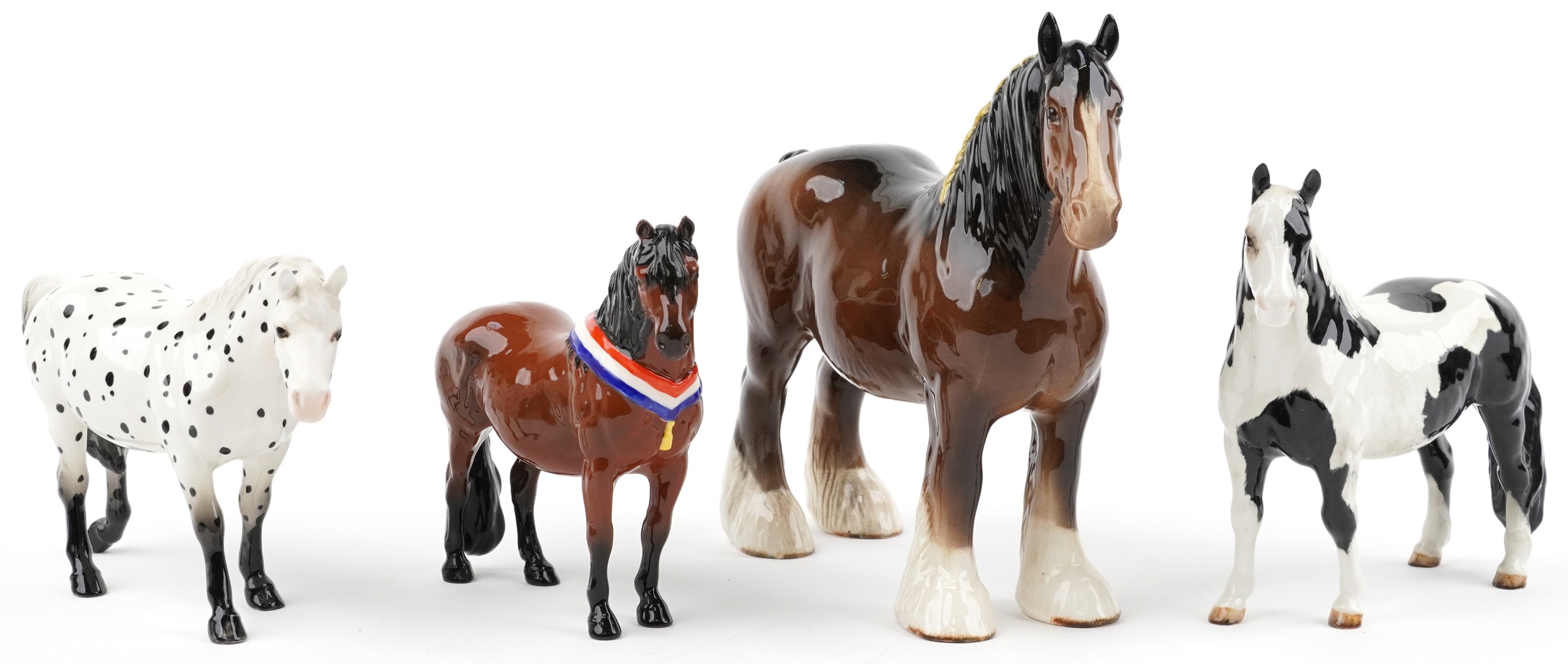 Four Beswick collectable horses including Clydesdale, Appaloosa, pinto pony and Piebald pinto