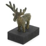 Middle Eastern Luristan type bronze of a deer raised on a rectangular black painted wooden base,