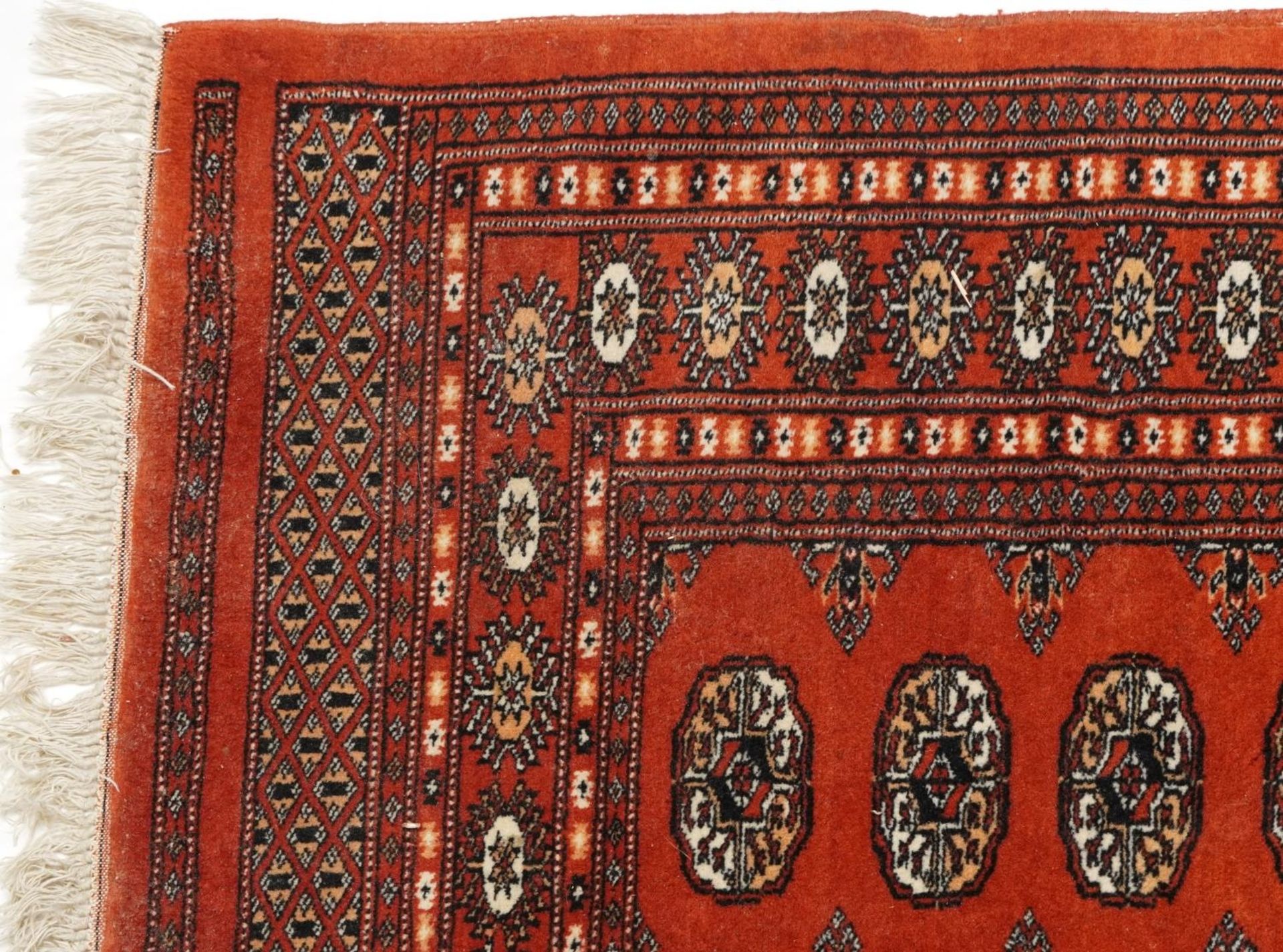 Rectangular Turkish Bokhara peach ground rug having an allover repeat flower head design, 150cm x - Bild 2 aus 4