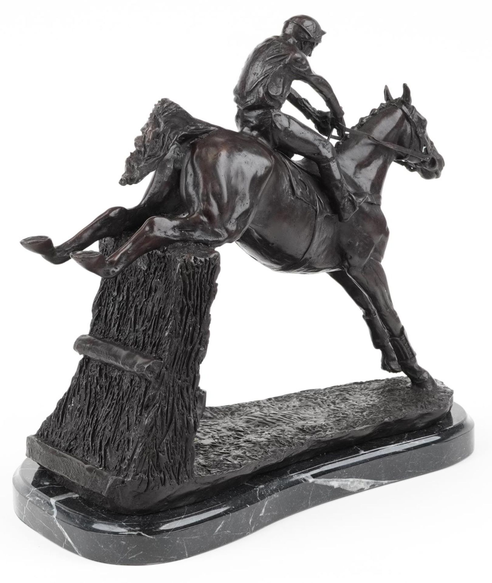 Patinated bronze statue of a jockey on horseback raised on a shaped black marble base, 35cm in - Image 2 of 3
