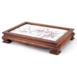 Chinese hardwood stand housing a porcelain panel decorated with birds amongst flowers, signed with