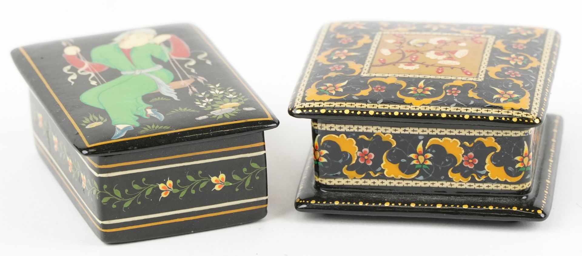 Two Islamic black lacquered boxes and covers including an example hand painted with flowers, the