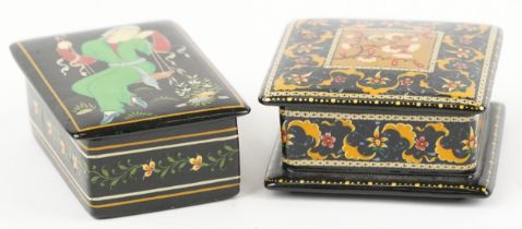 Two Islamic black lacquered boxes and covers including an example hand painted with flowers, the