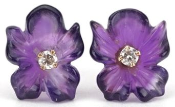 Pair of unmarked gold diamond solitaire and amethyst flower head stud earrings, each diamond