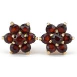 Pair of 9ct gold garnet flower head stud earrings, each 8mm in diameter, total 0.8g