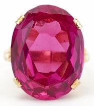 Chinese 22K gold ruby ring with openwork setting, character marks around the band, the ruby