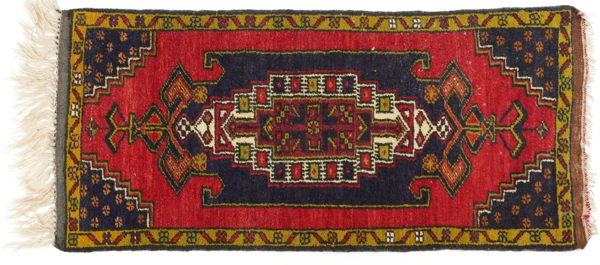 Rectangular Persian red and blue ground rug having an allover repeat floral design, 120cm x 53.5cm