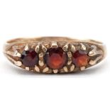 9ct gold garnet three stone ring, size N, 1.9g