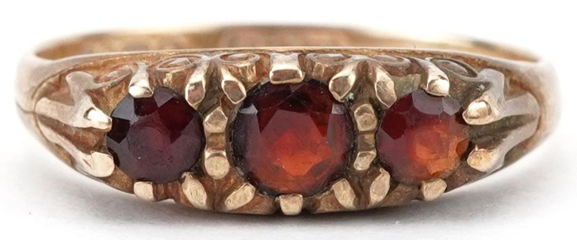 9ct gold garnet three stone ring, size N, 1.9g