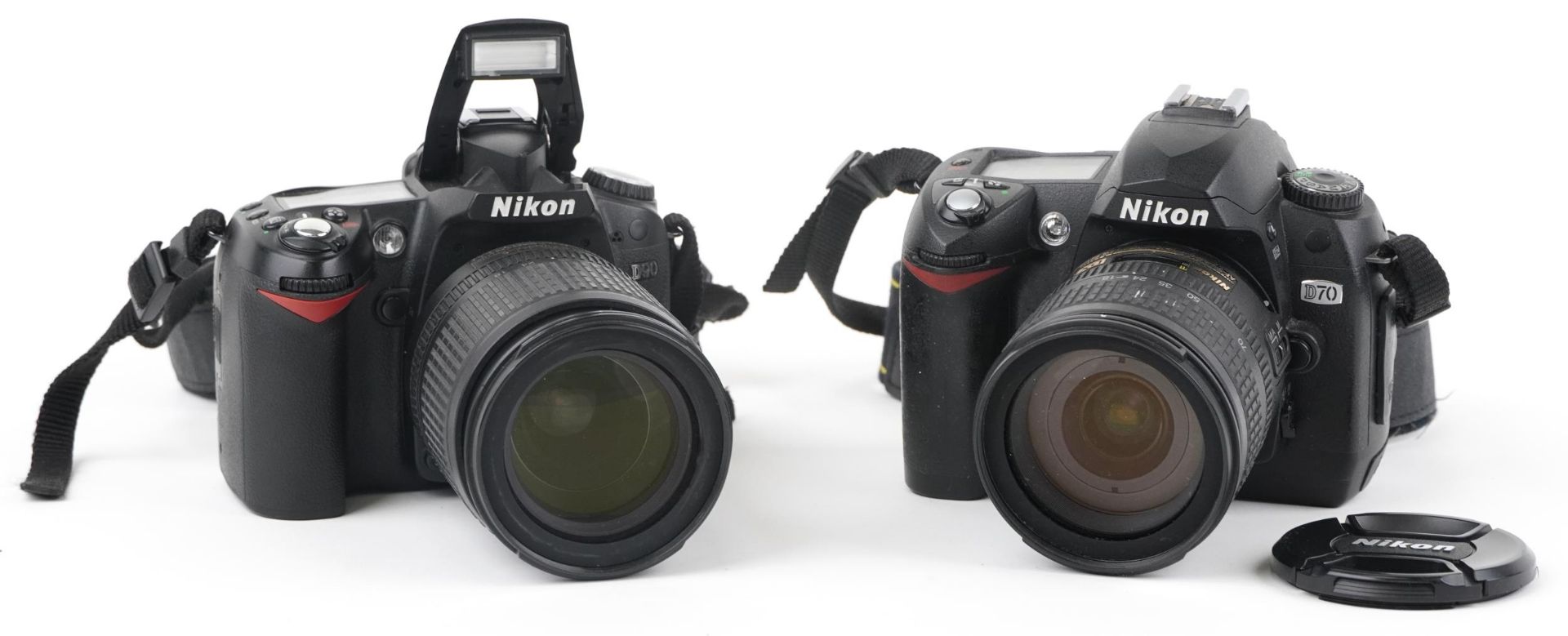 Two Nikon cameras with lenses comprising D 90 with Nikon DX AF-F Nikkor 18-105mm lens and D70 with