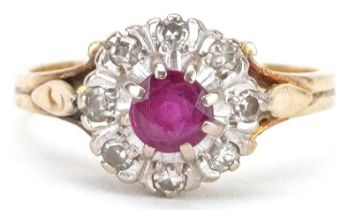 18ct gold ruby and diamond cluster ring, the ruby approximately 4.40mm in diameter, each diamond