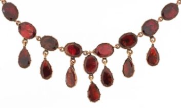 19th century rose gold oval garnet fringe necklace with closed foil backs, the clasp stamped 9KT,