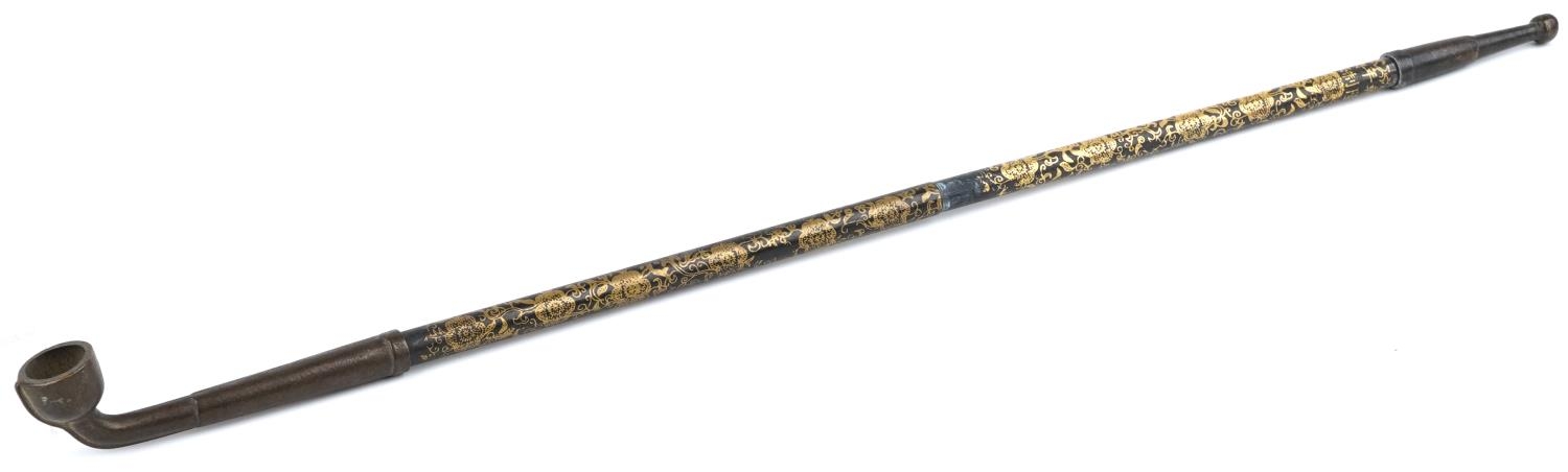 Chinese patinated bronze and metal opium pipe with foliate decoration, 48cm in length