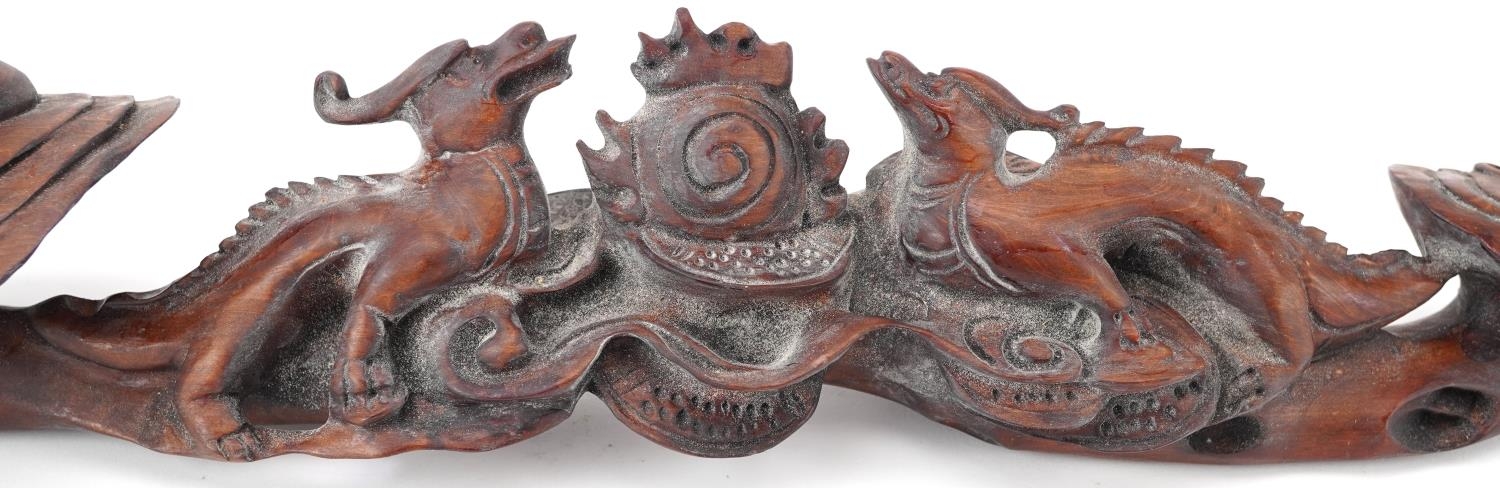Chinese hardwood ruyi sceptre carved with two dragons chasing the flaming pearl, 43cm wide - Image 3 of 8