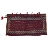 Rectangular Afghan red ground saddle bag having an allover repeat design, 150cm x 80cm